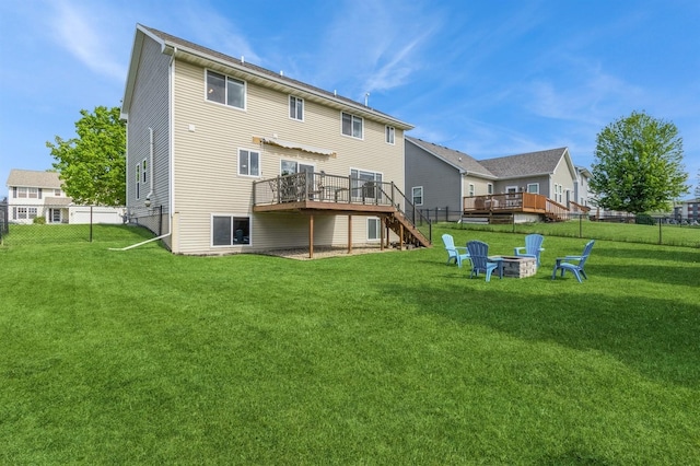 900 SE Woodbine Dr, Grimes, IA 50111 - rear view of property featuring a wooden deck, stairway, and an outdoor fire pit