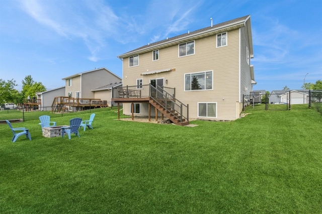 900 SE Woodbine Dr, Grimes, IA 50111 - rear view of property featuring stairs, a wooden deck, and an outdoor fire pit