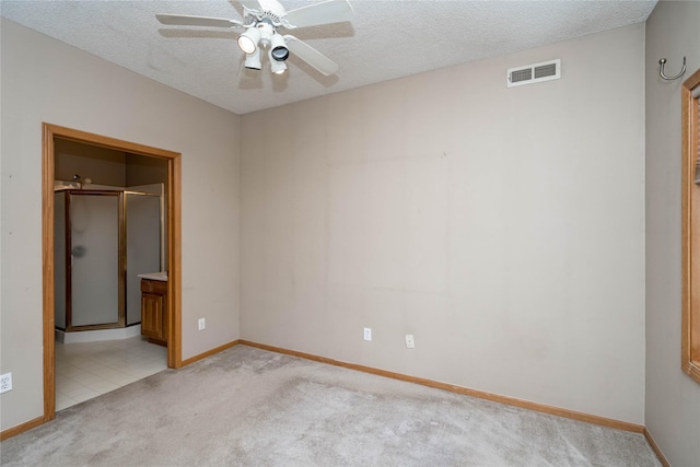 2433 Patricia Dr Unit 24, Urbandale, IA 50322 - unfurnished bedroom featuring light colored carpet, baseboards, a textured ceiling, ensuite bath, and ceiling fan