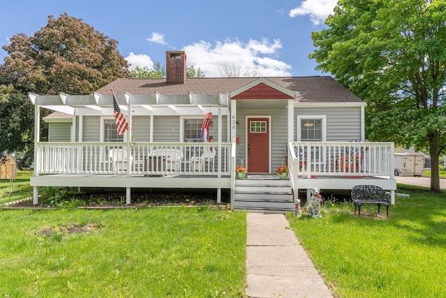 620 W Filmore St, Winterset, IA 50273 - bungalow featuring a front lawn, a chimney, a shingled roof, a deck, and a pergola