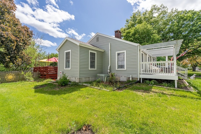 620 W Filmore St, Winterset, IA 50273 - back of property featuring a wooden deck, a chimney, and cooling unit