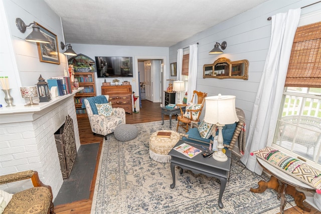 620 W Filmore St, Winterset, IA 50273 - living room with wood finished floors and wood walls