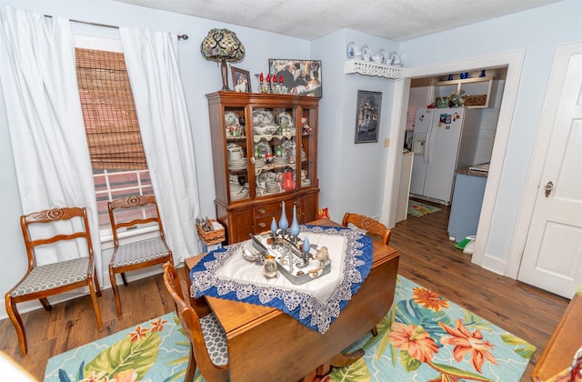 620 W Filmore St, Winterset, IA 50273 - dining space with wood finished floors and a textured ceiling
