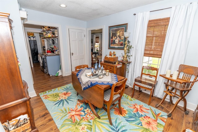 620 W Filmore St, Winterset, IA 50273 - dining room featuring wood finished floors, a textured ceiling, recessed lighting, and baseboards