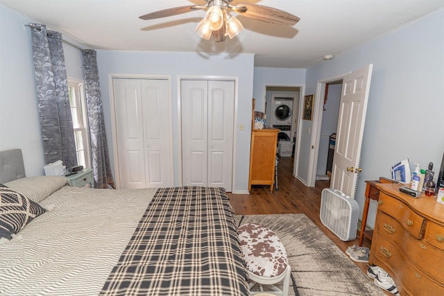 620 W Filmore St, Winterset, IA 50273 - bedroom with stacked washer / dryer, two closets, wood finished floors, a ceiling fan, and crown molding
