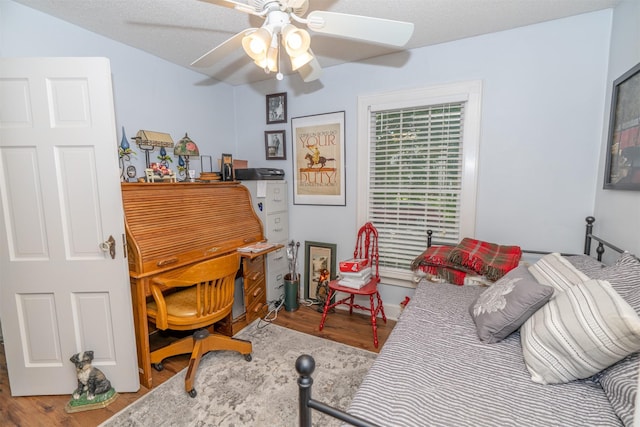 620 W Filmore St, Winterset, IA 50273 - bedroom with wood finished floors and a ceiling fan