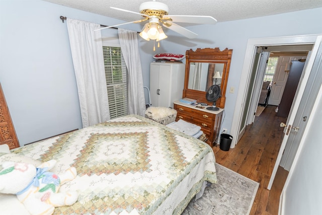 620 W Filmore St, Winterset, IA 50273 - bedroom with wood finished floors, a textured ceiling, and a ceiling fan