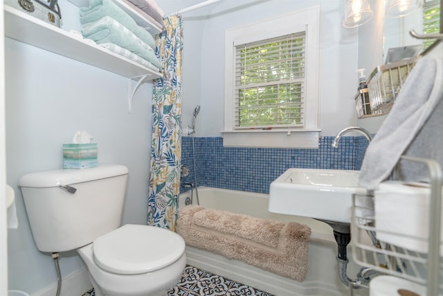 620 W Filmore St, Winterset, IA 50273 - full bath with shower / tub combo with curtain, toilet, and tile patterned floors