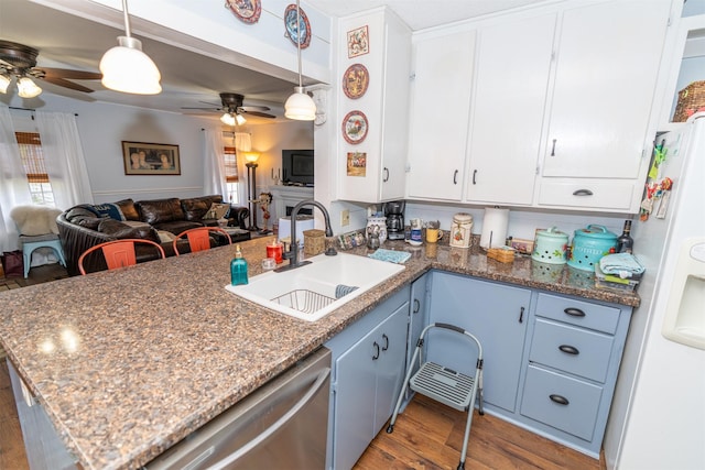 620 W Filmore St, Winterset, IA 50273 - kitchen with a sink, dishwasher, white refrigerator with ice dispenser, a ceiling fan, and a peninsula