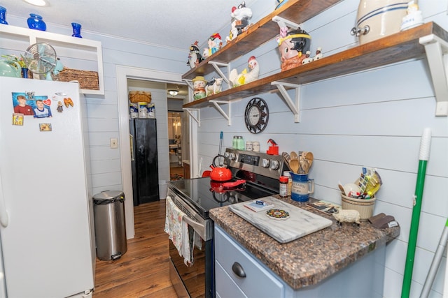 620 W Filmore St, Winterset, IA 50273 - kitchen featuring freestanding refrigerator, electric stove, dark wood-type flooring, open shelves, and a textured ceiling