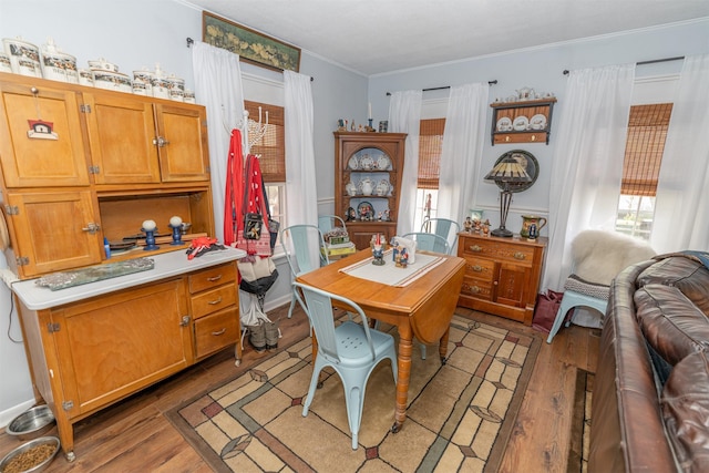 620 W Filmore St, Winterset, IA 50273 - dining area with light wood-type flooring and ornamental molding