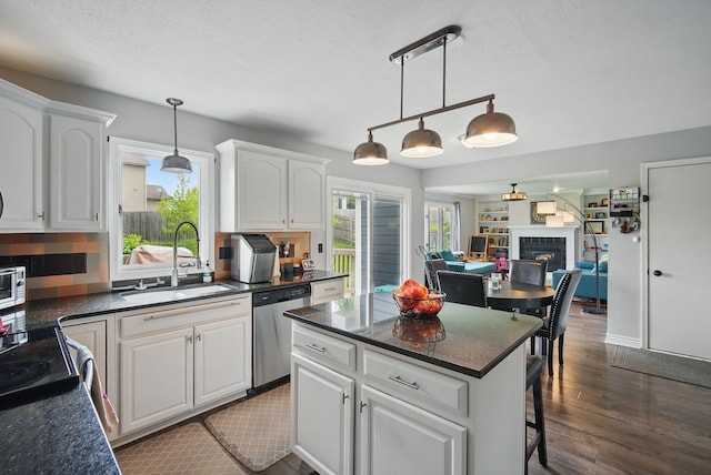 6173 Pommel Pl, West Des Moines, IA 50266 - kitchen featuring stainless steel dishwasher, a sink, white cabinets, dark wood finished floors, and a textured ceiling