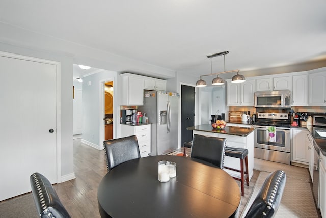 6173 Pommel Pl, West Des Moines, IA 50266 - dining area featuring wood finished floors and baseboards