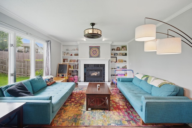 6173 Pommel Pl, West Des Moines, IA 50266 - living room featuring built in shelves, a fireplace, and ornamental molding
