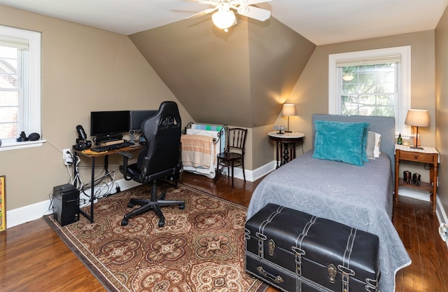 2118 34th St, Des Moines, IA 50310 - bedroom featuring wood finished floors, multiple windows, baseboards, lofted ceiling, and a desk