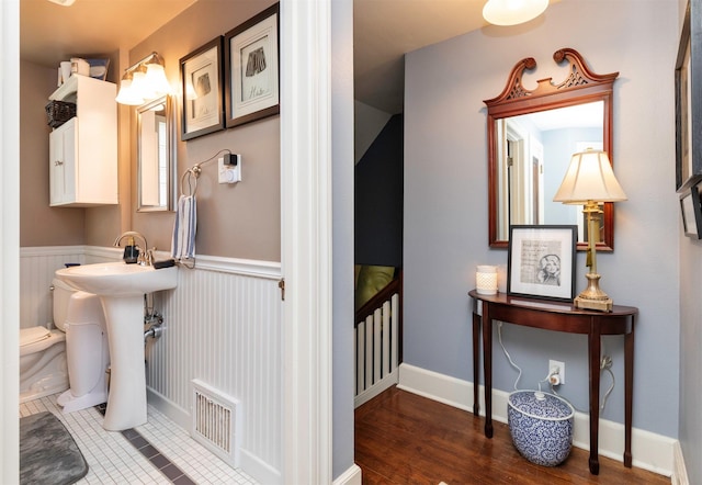 2118 34th St, Des Moines, IA 50310 - bathroom with toilet and a wainscoted wall