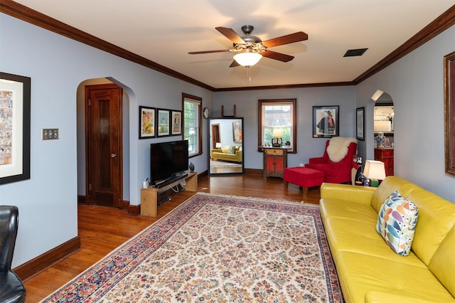 2118 34th St, Des Moines, IA 50310 - living area featuring arched walkways, wood finished floors, a ceiling fan, baseboards, and crown molding