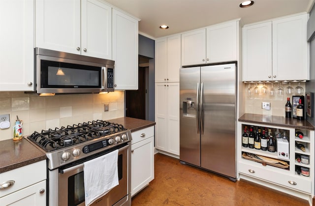 2118 34th St, Des Moines, IA 50310 - kitchen featuring stainless steel appliances, dark countertops, decorative backsplash, white cabinets, and recessed lighting