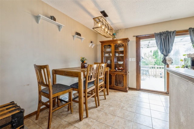 1903 W 5th Ave, Indianola, IA 50125 - dining room with a textured ceiling and light tile patterned flooring