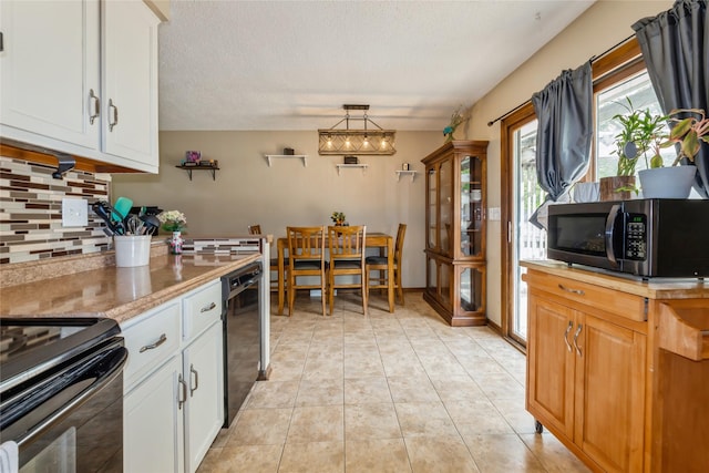 1903 W 5th Ave, Indianola, IA 50125 - kitchen with stainless steel microwave, tasteful backsplash, dishwasher, white cabinets, and a textured ceiling