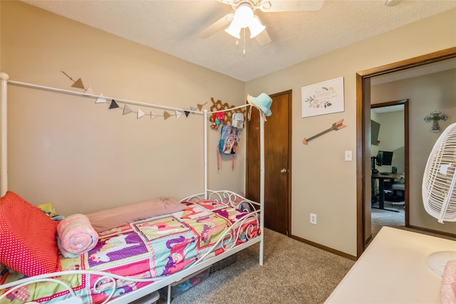 1903 W 5th Ave, Indianola, IA 50125 - carpeted bedroom with ceiling fan, a textured ceiling, and baseboards
