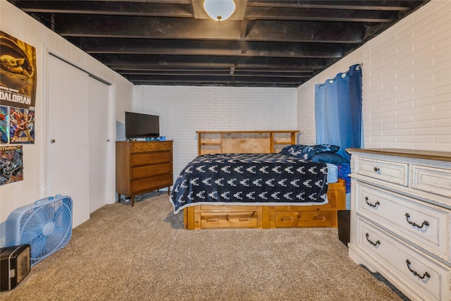 1903 W 5th Ave, Indianola, IA 50125 - carpeted bedroom featuring a closet and brick wall