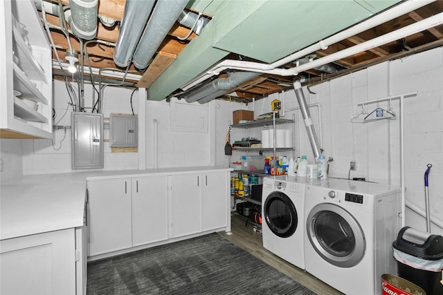 2740 Forest Dr, Des Moines, IA 50312 - laundry room featuring washer and clothes dryer, cabinet space, electric panel, and dark wood-style flooring