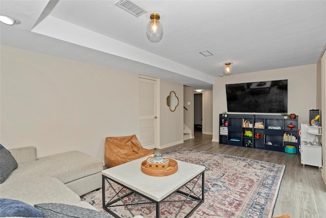 2740 Forest Dr, Des Moines, IA 50312 - living area featuring wood finished floors, stairway, and baseboards