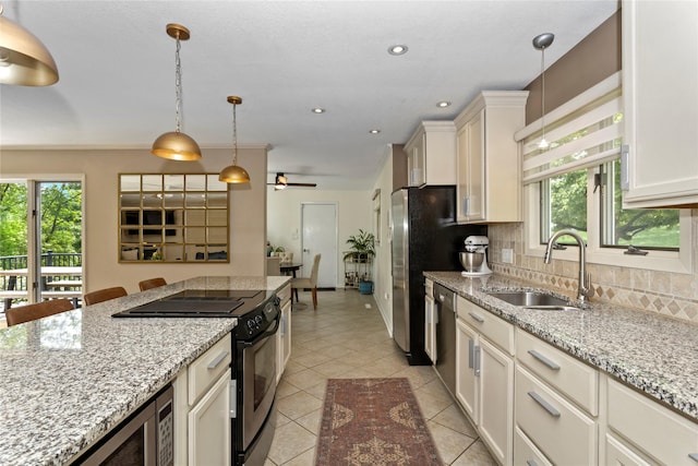 2740 Forest Dr, Des Moines, IA 50312 - kitchen with stainless steel appliances, a sink, decorative backsplash, healthy amount of natural light, and recessed lighting