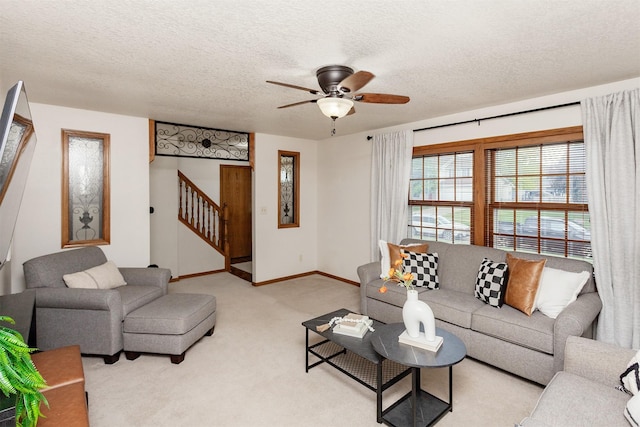 310 NE Meadowlark Ln, Waukee, IA 50263 - living room with stairs, a ceiling fan, light colored carpet, and a textured ceiling