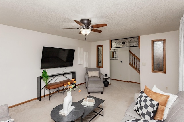 310 NE Meadowlark Ln, Waukee, IA 50263 - carpeted living room with stairs, a ceiling fan, and a textured ceiling