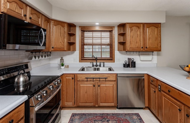 310 NE Meadowlark Ln, Waukee, IA 50263 - kitchen with stainless steel appliances, open shelves, brown cabinets, and tasteful backsplash