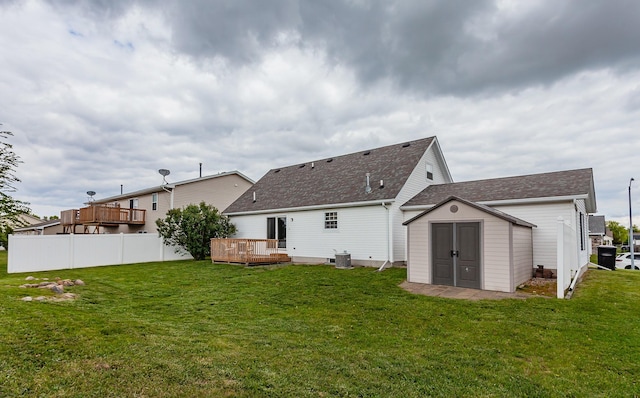 310 NE Meadowlark Ln, Waukee, IA 50263 - back of property featuring a shed, a wooden deck, a yard, and roof with shingles