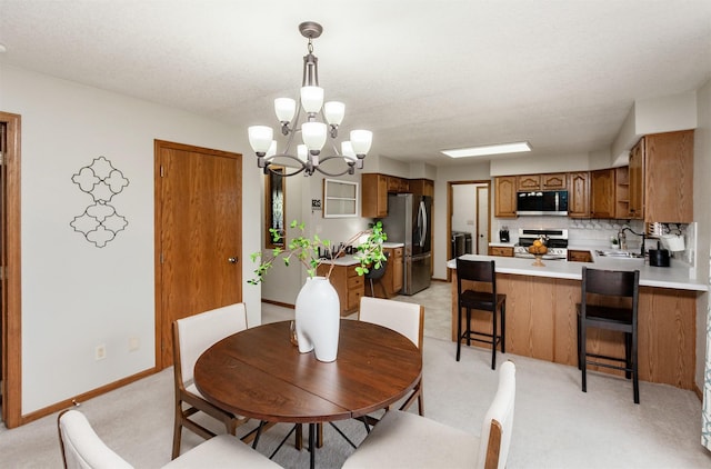 310 NE Meadowlark Ln, Waukee, IA 50263 - dining space with a chandelier and light carpet