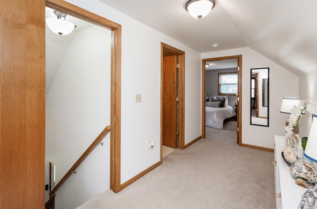 310 NE Meadowlark Ln, Waukee, IA 50263 - corridor featuring an upstairs landing, light carpet, and vaulted ceiling
