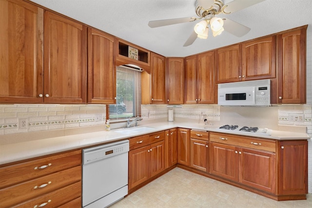 2700 Dosh Rd, Des Moines, IA 50310 - kitchen featuring white appliances, a sink, and brown cabinetry
