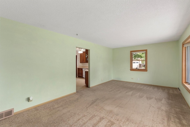 2700 Dosh Rd, Des Moines, IA 50310 - spare room with light colored carpet, a textured ceiling, and baseboards