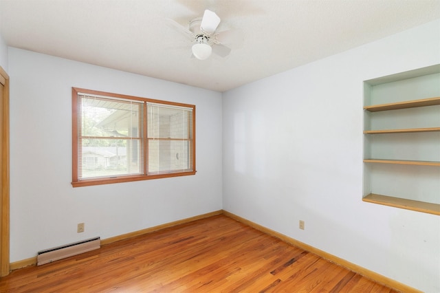 2700 Dosh Rd, Des Moines, IA 50310 - unfurnished room featuring a baseboard radiator, light wood finished floors, and baseboards