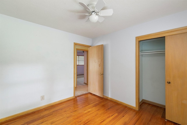 2700 Dosh Rd, Des Moines, IA 50310 - unfurnished bedroom featuring a closet, light wood-style floors, baseboards, and a ceiling fan