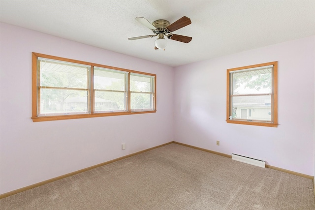 2700 Dosh Rd, Des Moines, IA 50310 - carpeted spare room featuring a baseboard radiator, plenty of natural light, and baseboards