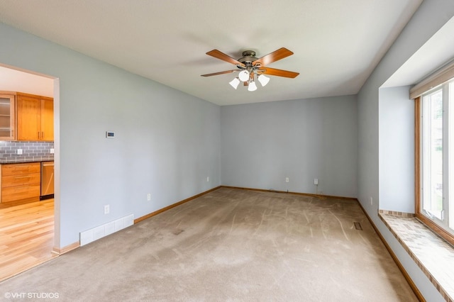 4337 Park Ct, Urbandale, IA 50322 - unfurnished room featuring ceiling fan, light colored carpet, and baseboards