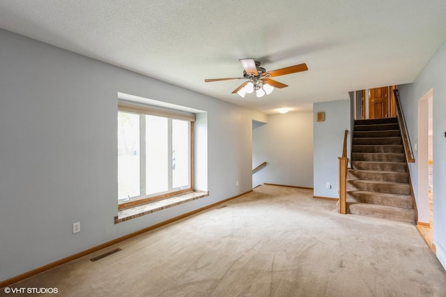 4337 Park Ct, Urbandale, IA 50322 - unfurnished living room with ceiling fan, baseboards, carpet floors, and stairs