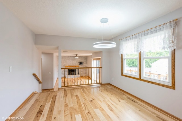 4337 Park Ct, Urbandale, IA 50322 - empty room with wood finished floors, baseboards, and a chandelier