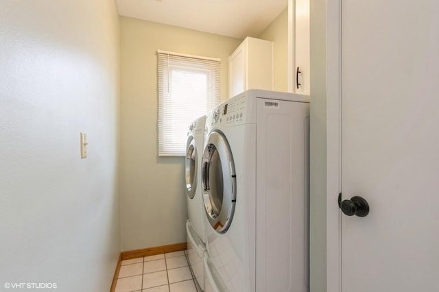 4337 Park Ct, Urbandale, IA 50322 - washroom with washing machine and clothes dryer, cabinet space, baseboards, and light tile patterned floors