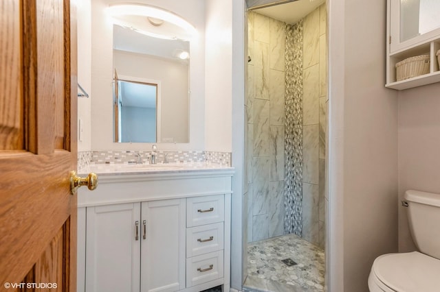 4337 Park Ct, Urbandale, IA 50322 - bathroom with toilet, vanity, a shower stall, and tasteful backsplash