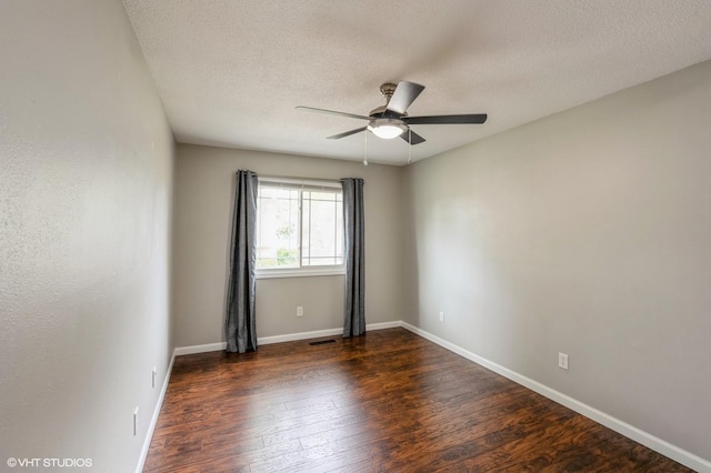 4337 Park Ct, Urbandale, IA 50322 - unfurnished room with ceiling fan, dark wood-type flooring, baseboards, and a textured ceiling