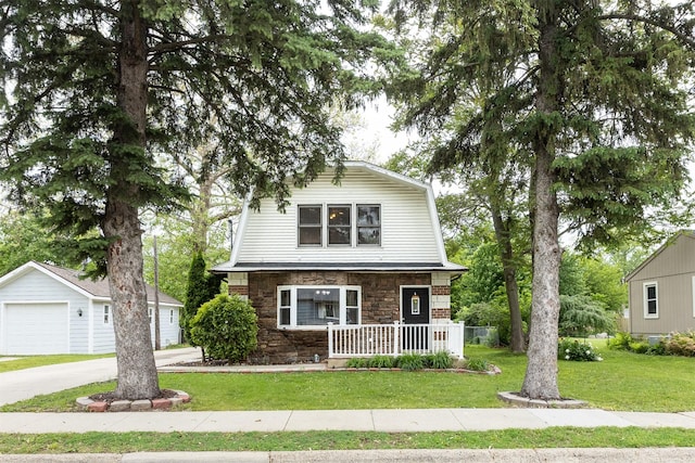 3919 69th St, Urbandale, IA 50322 - colonial inspired home with a porch, stone siding, a gambrel roof, a front lawn, and a garage