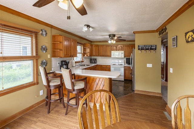 3919 69th St, Urbandale, IA 50322 - kitchen with white appliances, open shelves, ceiling fan, a sink, and ornamental molding