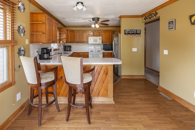 3919 69th St, Urbandale, IA 50322 - kitchen featuring white appliances, open shelves, a peninsula, a ceiling fan, and a sink