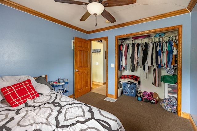 3919 69th St, Urbandale, IA 50322 - carpeted bedroom with crown molding, a closet, baseboards, and ceiling fan